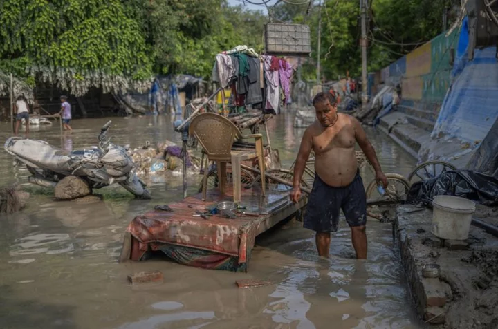 People living near Yamuna River in New Delhi return home as waters recede